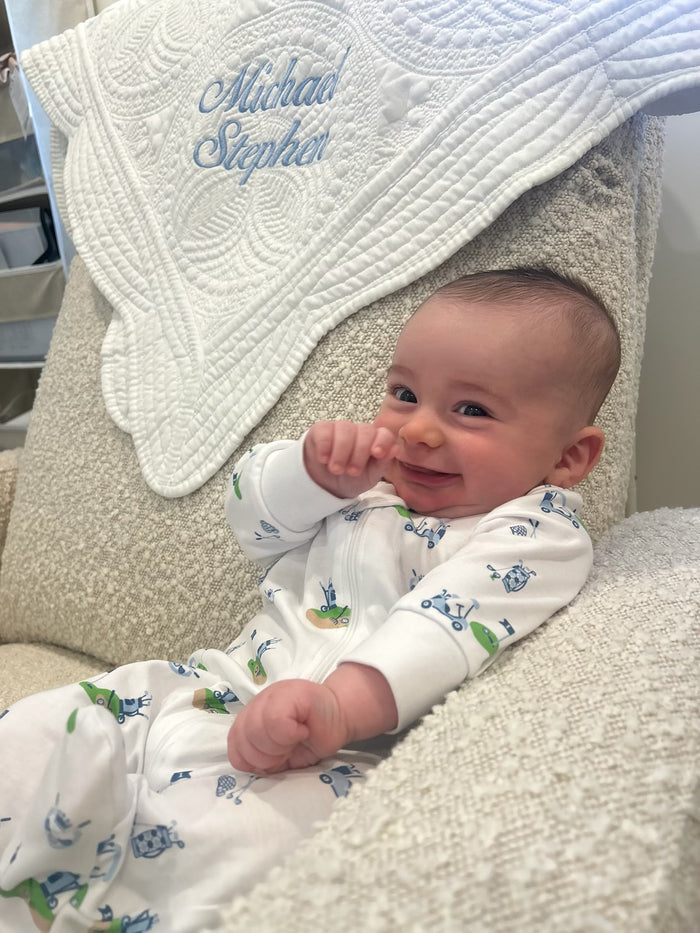 Personalized baby quilt — shown with embroidered name in pink