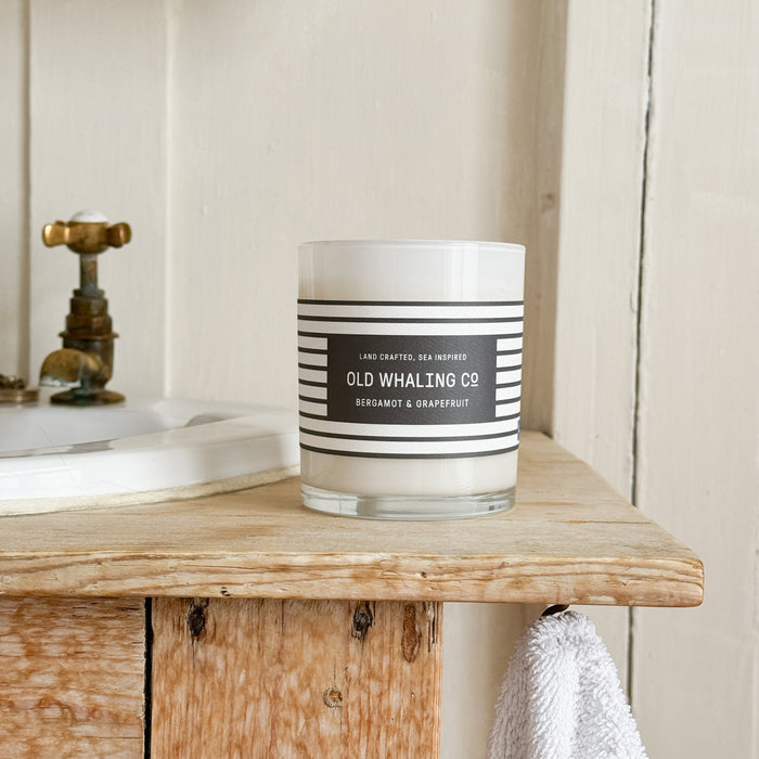 Front view of Bergamot & Grapefruit Candle on wood sink