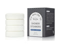 Set of white shower steamers with their packaging on a white background
