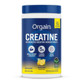 A white plastic tub of Orgain Creatine Micronized Creatine Monohydrate with a dark blue cap and a blue label featuring yellow accents, lemon graphics, and product details.