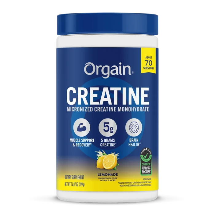 A white plastic tub of Orgain Creatine Micronized Creatine Monohydrate with a dark blue cap and a blue label featuring yellow accents, lemon graphics, and product details.