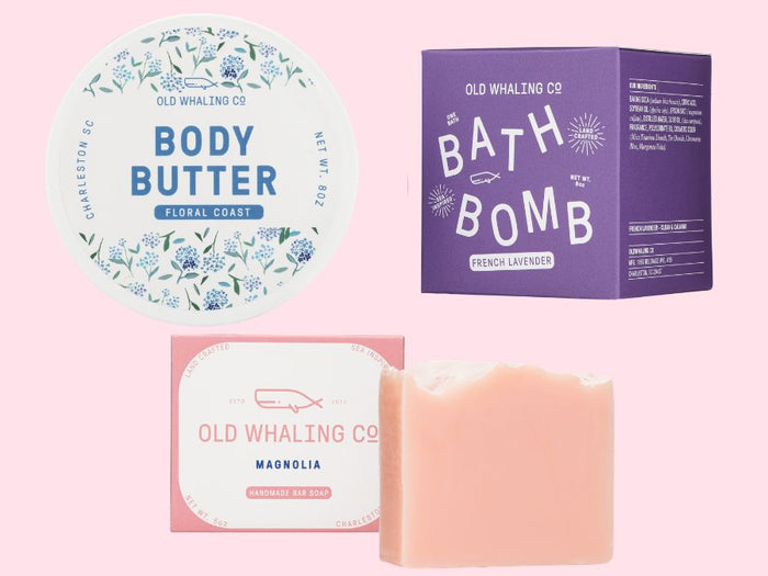 Old Whaling Co floral skincare products including body butter, bath bomb, and soap on a pink background