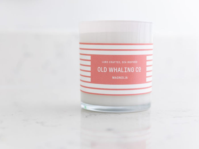 Magnolia candle on marble counter in bathroom
