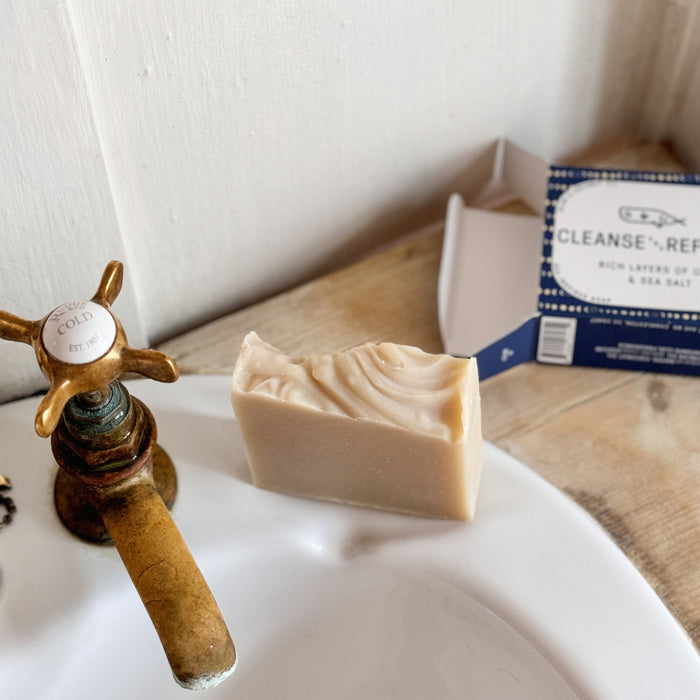 Unboxed Mariner's Moon Bar Soap sitting on sink beside open packaging