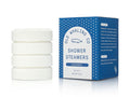 Set of four shower steamers with their packaging on a white background