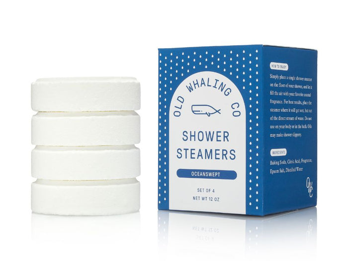 Set of four shower steamers with their packaging on a white background