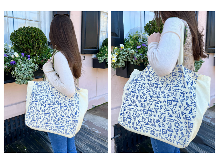 Old Whaling Co Canvas Printed Tote Bag held next to flower boxes in downtown Charleston