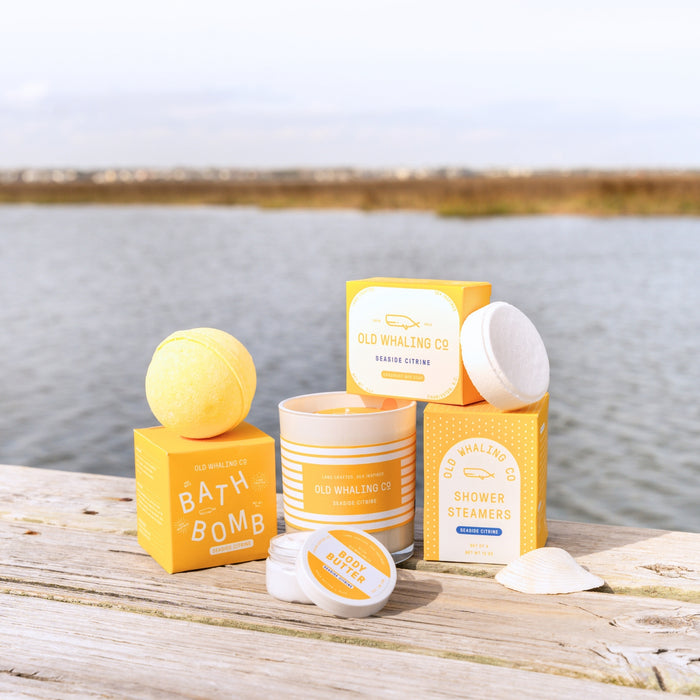 Close up of Seaside Citrine collection on wooden dock with coastal background