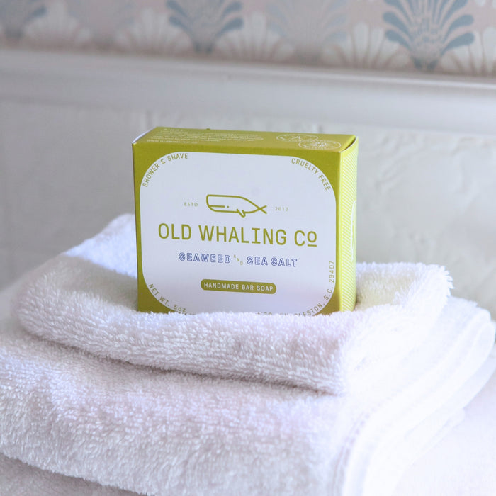Seaweed & Sea Salt Bar Soap box sits on stack of white towels