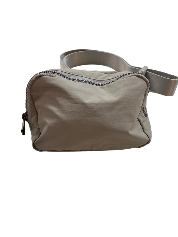 The Keely belt bag — shown open with compartments