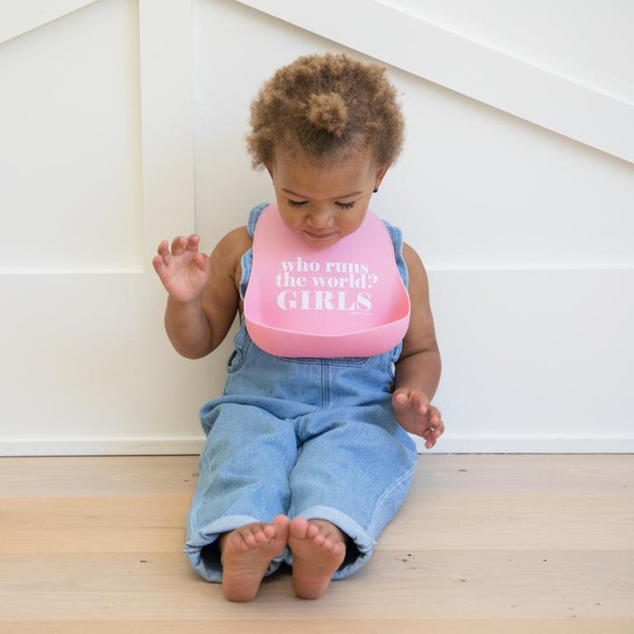Who Runs the World Wonder Bib — shown on baby